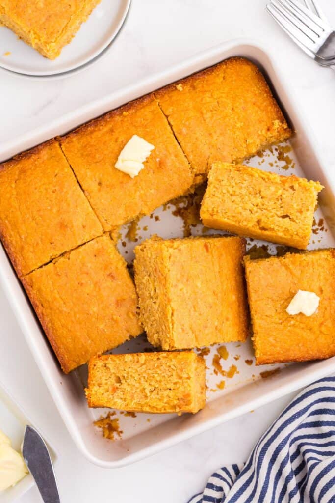 A square baking pan with sliced cornbread in it.