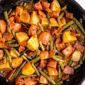 Completed green bean recipe in a cast iron pan.