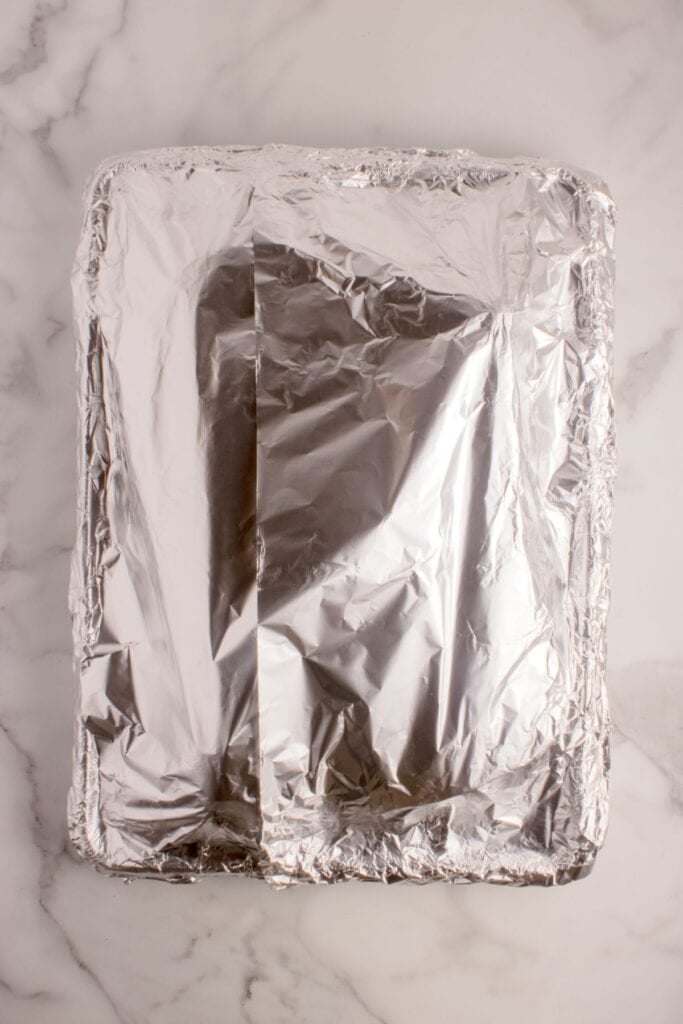 Ribs prepped and tented in aluminum foil.