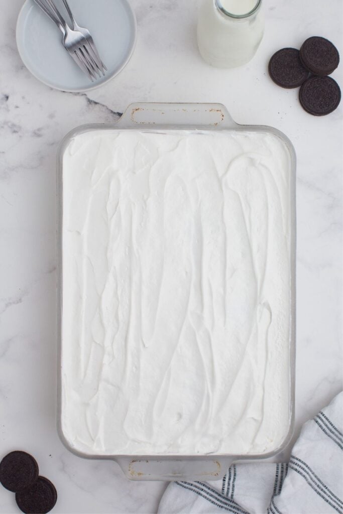 Remaining cream cheese mixture is dolloped and spread into an even layer on top of the chocolate pudding.