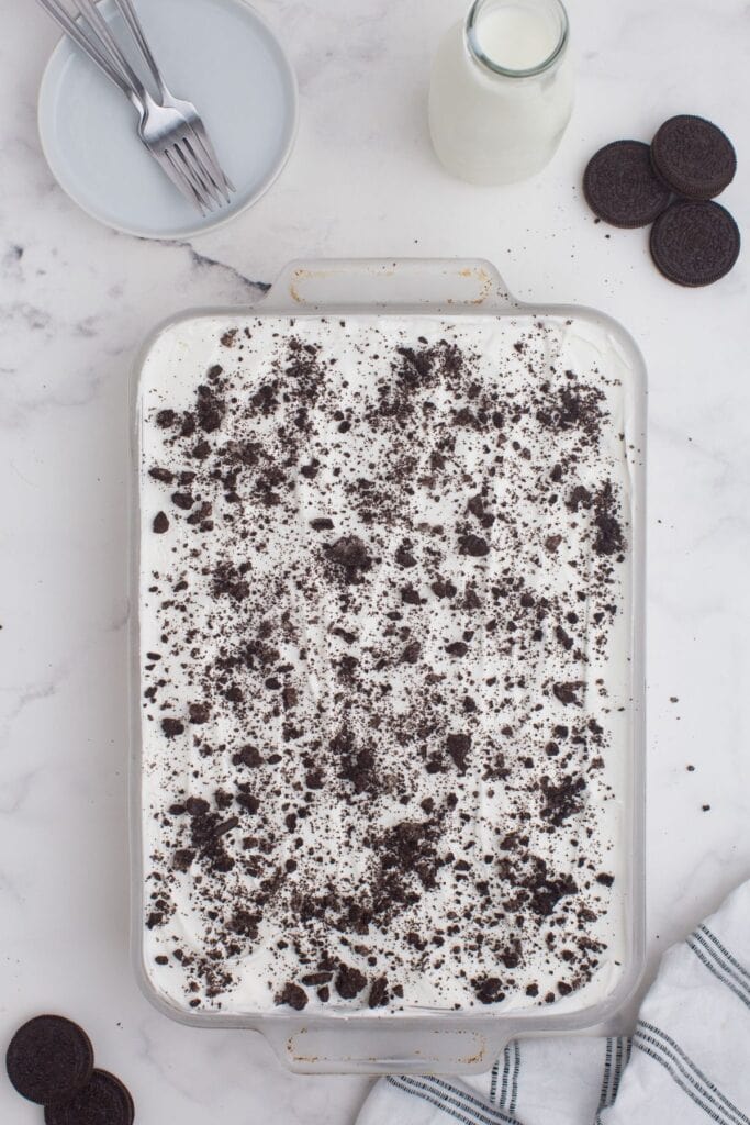 Lasagna is sprinkled with crushed Oreo cookies for garnish.