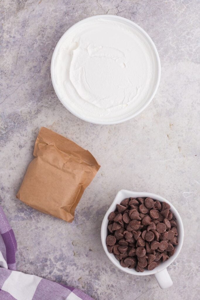Ingredients for Cool Whip candy: Cool Whip, instant chocolate pudding, and chocolate melts.