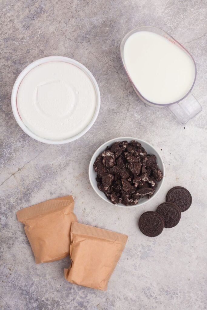 Ingredients for Oreo fluff: instant vanilla pudding, milk, Cool Whip, and Oreo cookies.