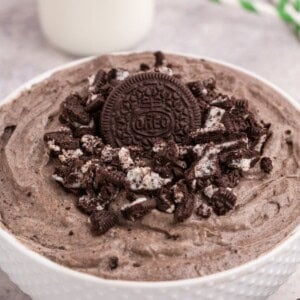 Oreo fluff in a white bowl with crushed Oreos on top.