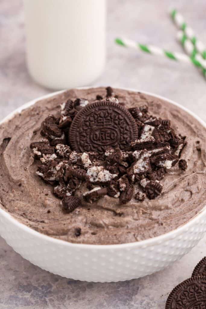 Oreo fluff in a white bowl with crushed Oreos on top.