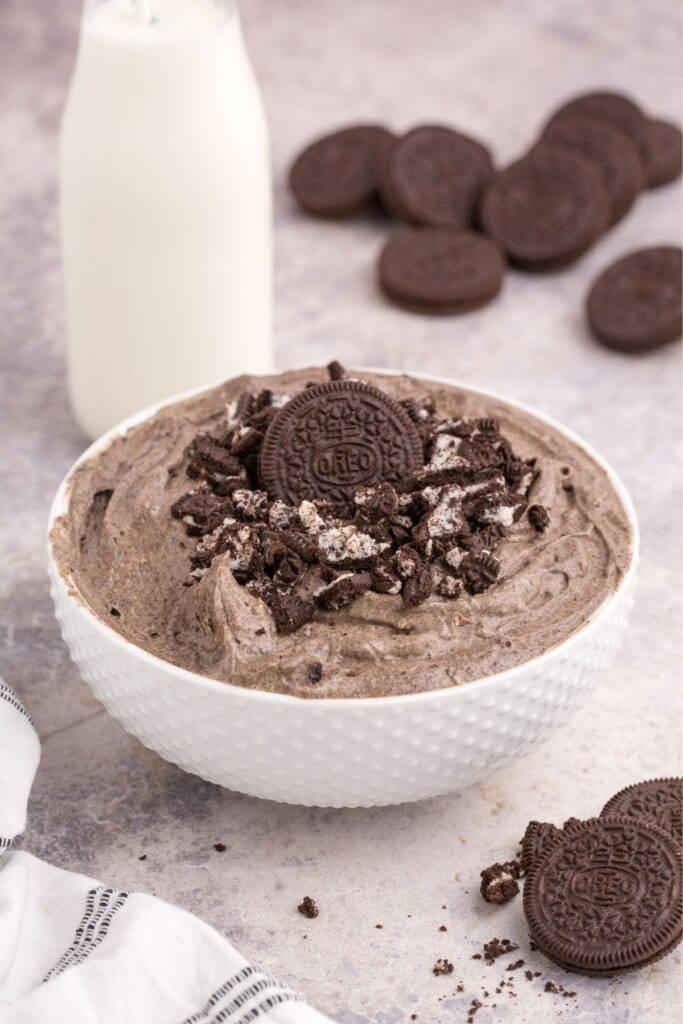 Oreo fluff in a white bowl with crushed Oreos on top.