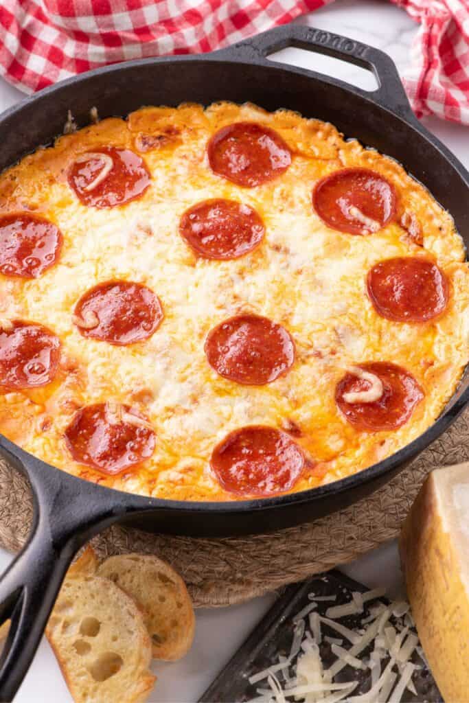 Baked pizza dip in a cast iron pan.