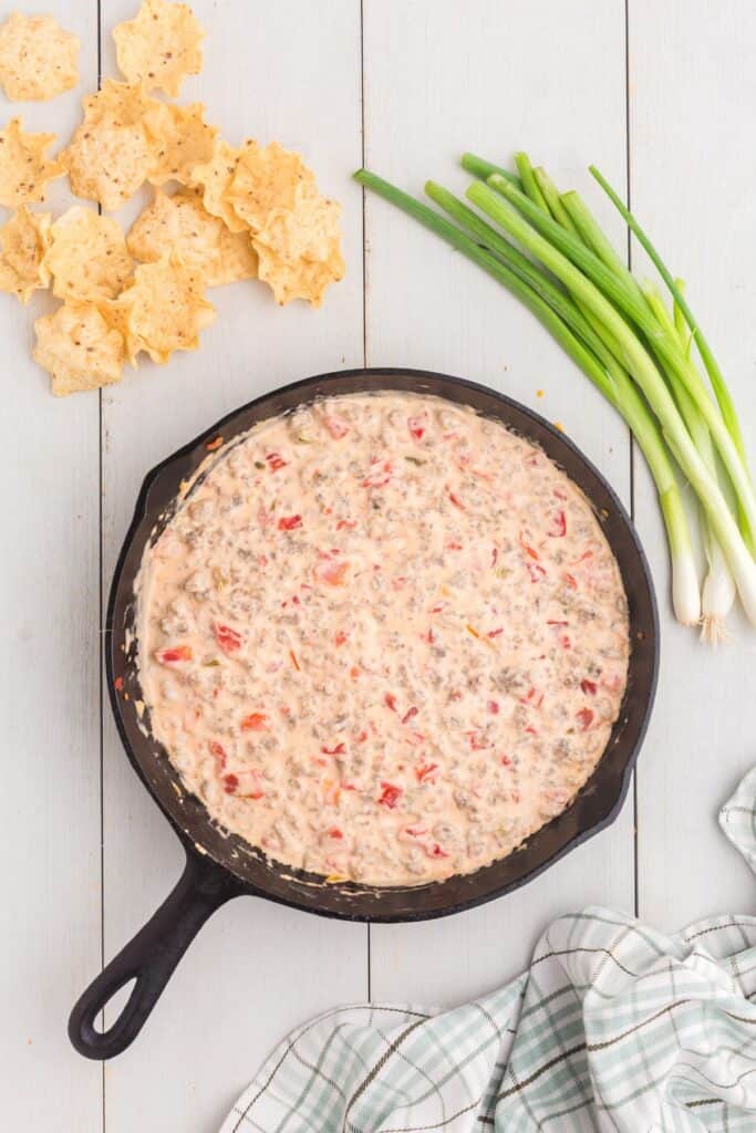 Completed sausage cream cheese dip in cast iron pan.