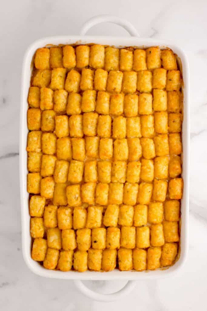 Casserole is topped with a layer of tater tots.