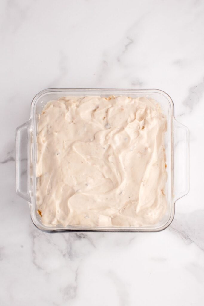 Gravy and mushroom soup layer added on top of turkey and mashed potatoes.