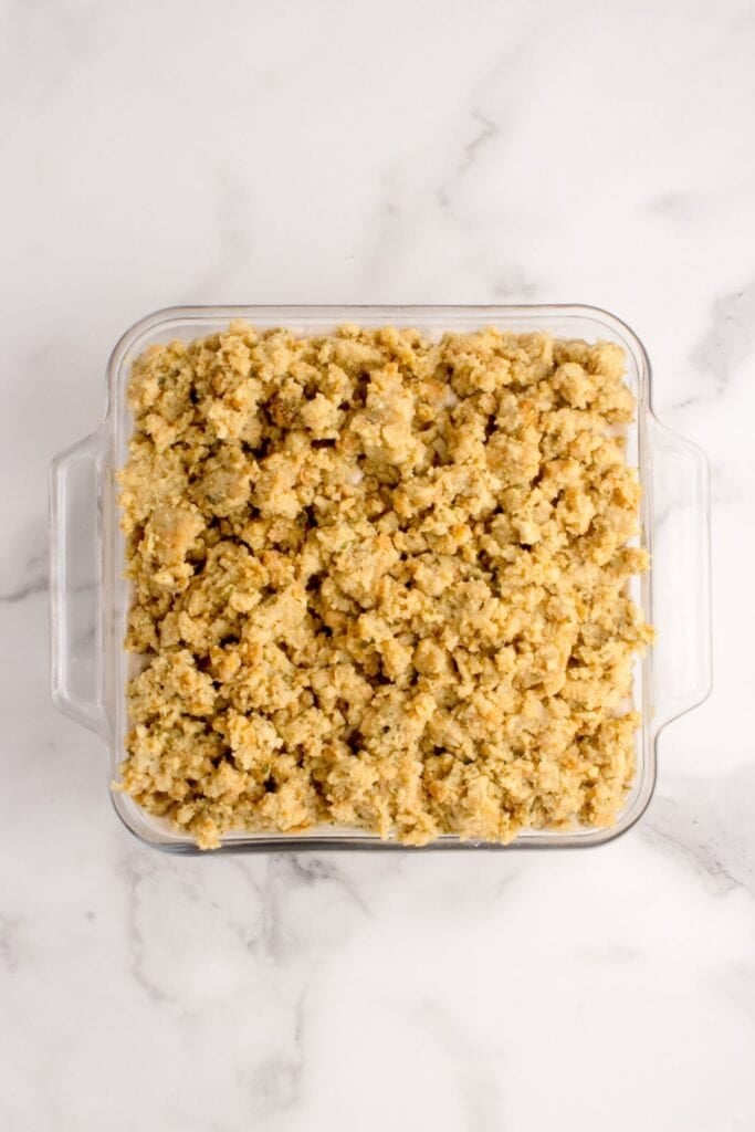 Leftover stuffing layered on top of gravy, turkey, and mashed potatoes.