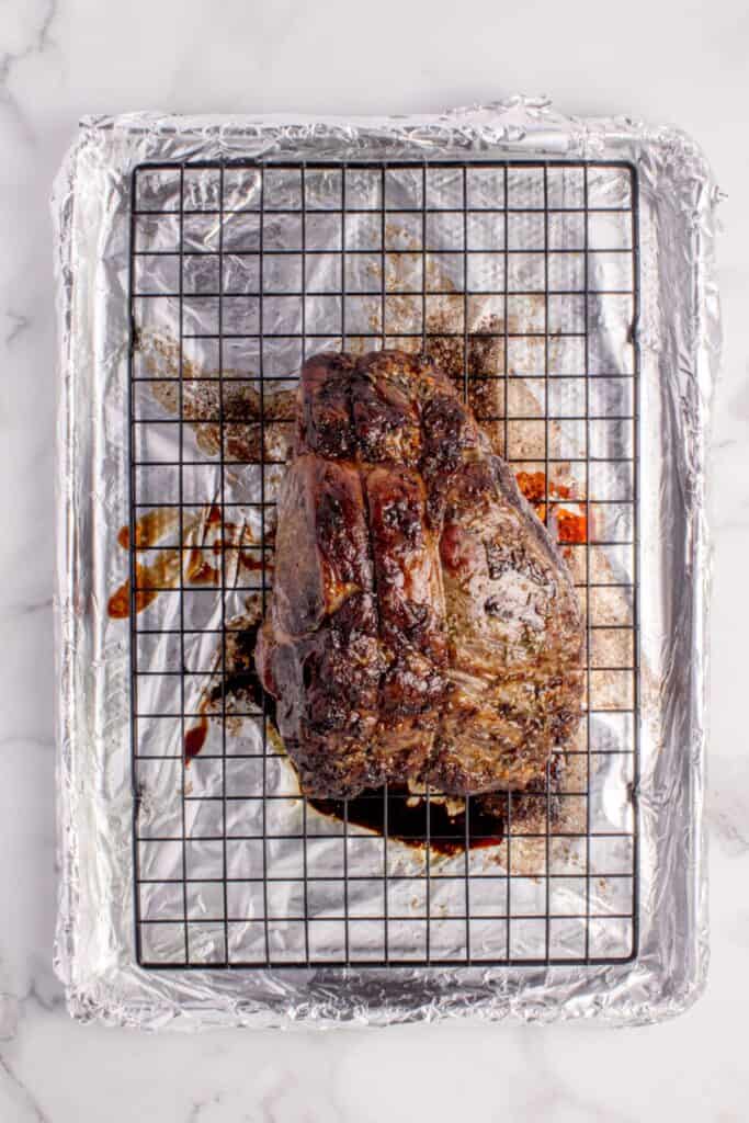 Completed prime rib on a aluminum foil lined baking sheet with a wire rack.