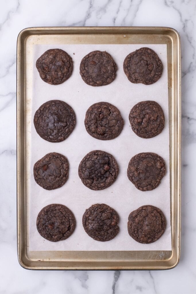Baked cookies on a parchment lined baking sheet.