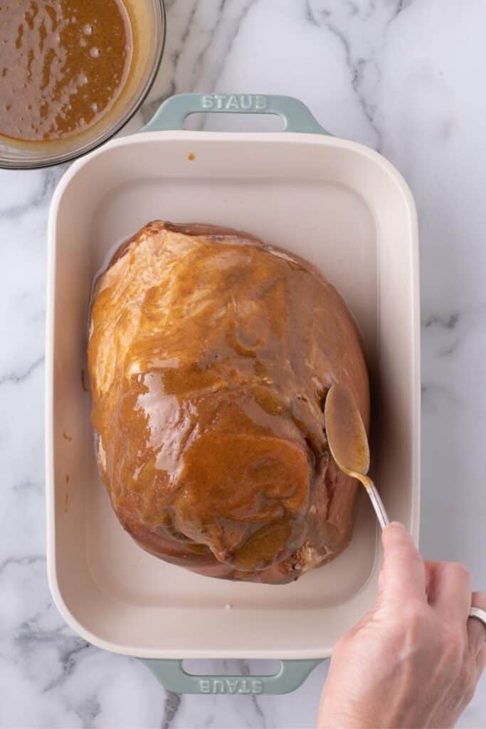 Cover the ham with the brown sugar, mustard, and clove mixture.