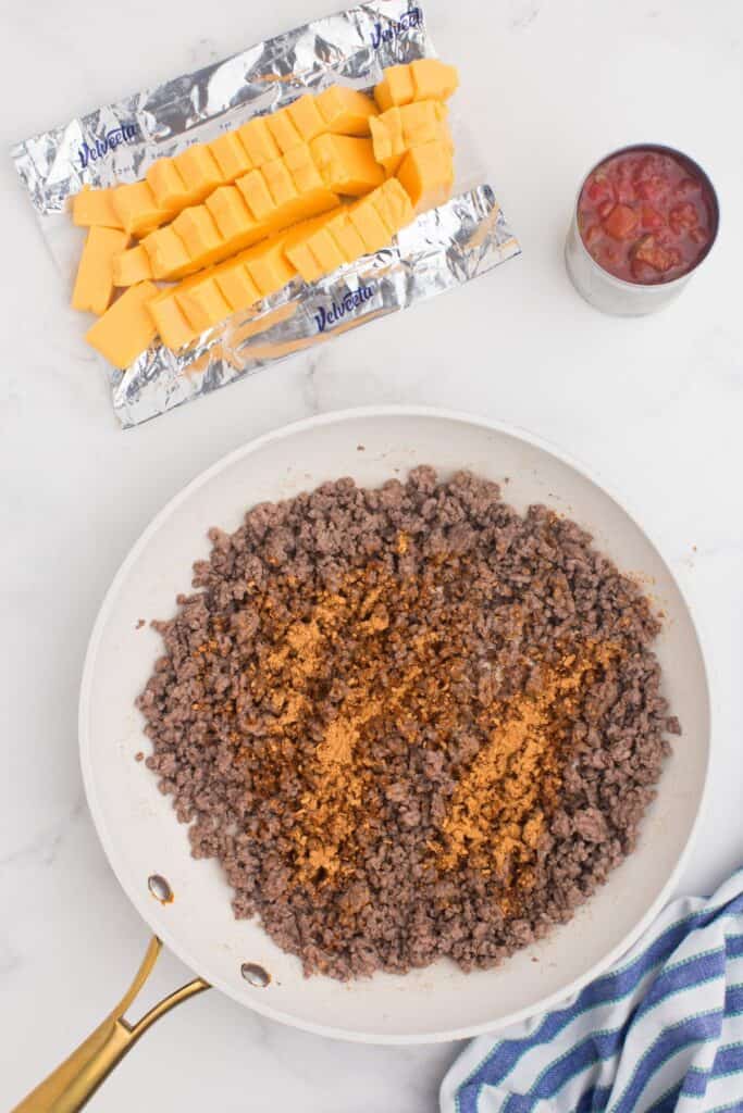 Ground beef in a large skillet with taco seasoning.