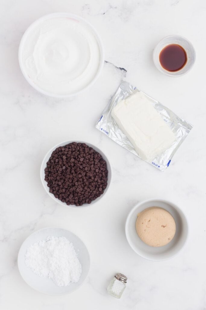 Ingredients for Cookie Dough Dip: Cool Whip, vanilla, cream cheese, chocolate chips, brown sugar, powdered sugar, and salt.