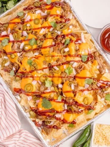 Easy pulled pork nachos on a baking sheet.