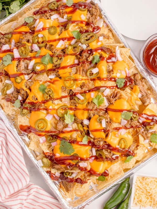 Easy pulled pork nachos on a baking sheet.