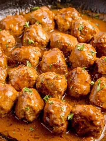 Completed meatballs and gravy recipe in a cast iron pan.