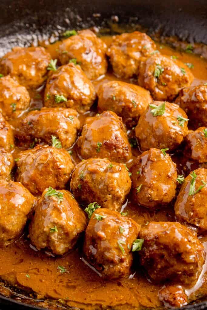 Completed meatballs and gravy recipe in a cast iron pan.