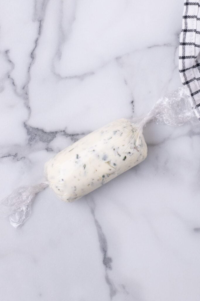 plastic wrap rolled around compound butter to form a tube.