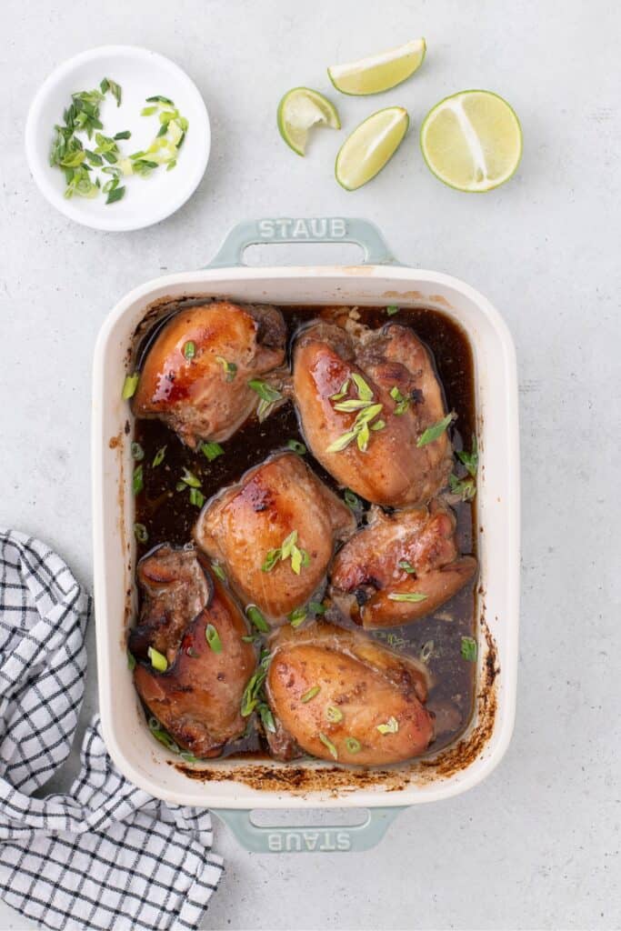 Completed chicken thighs in a blue baking dish.