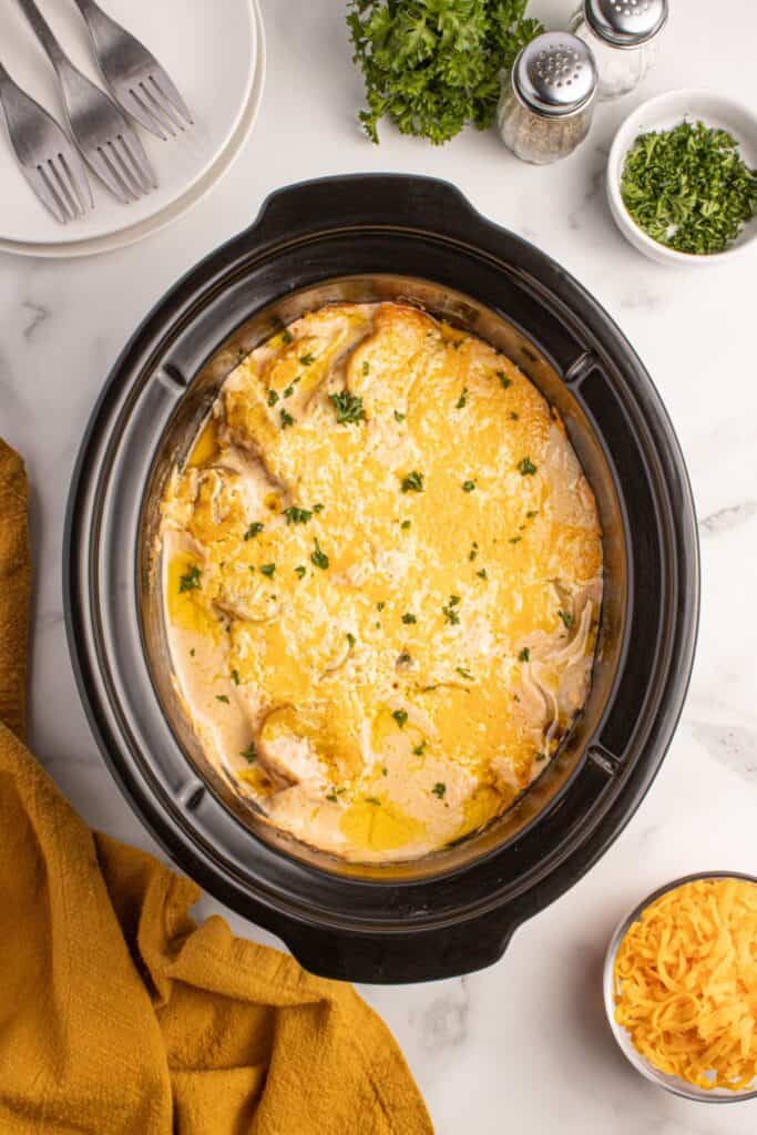 Completed scalloped potatoes in the crockpot insert.