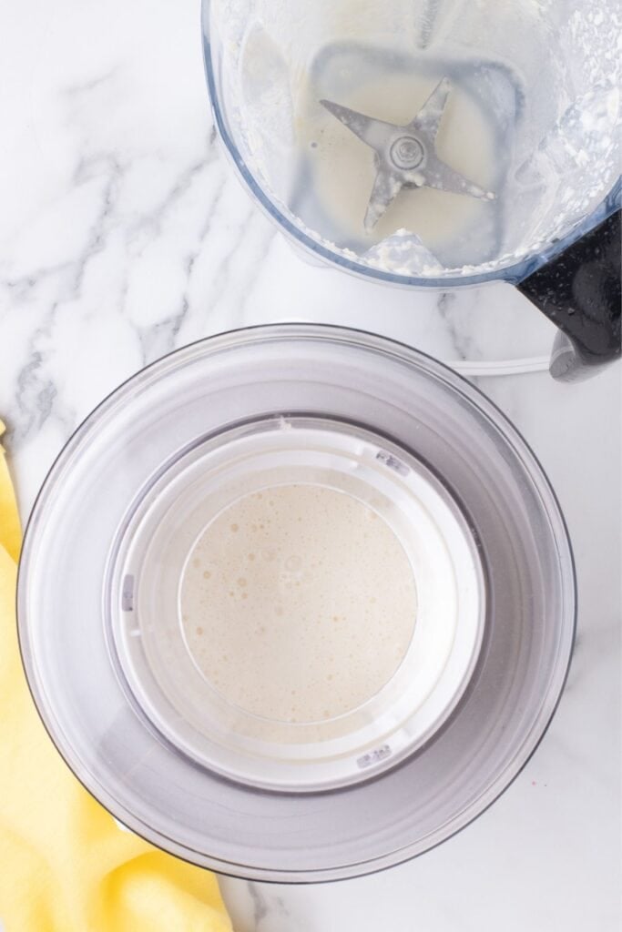 Pineapple mixture is poured into an ice cream maker.