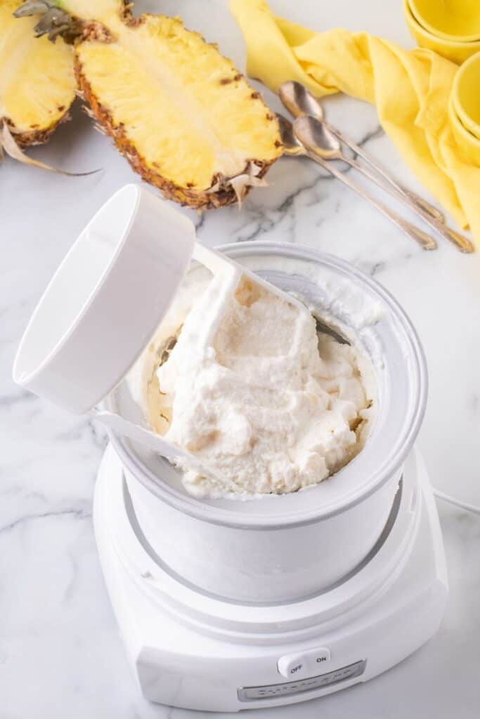 An ice cream maker with the churning piece partially removed. The ice cream looks like soft serve.