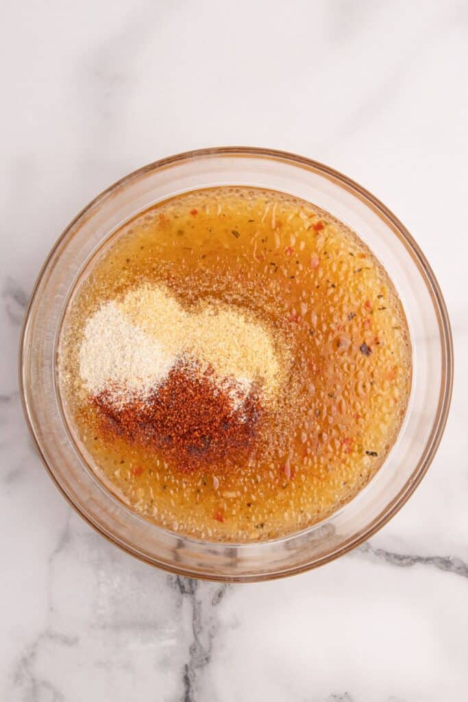 Marinade for pork steaks in a glass mixing bowl.