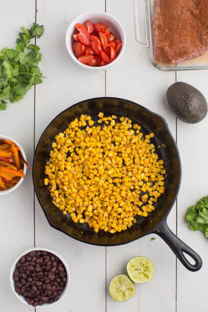 Corn cooking in a cast iron pan.