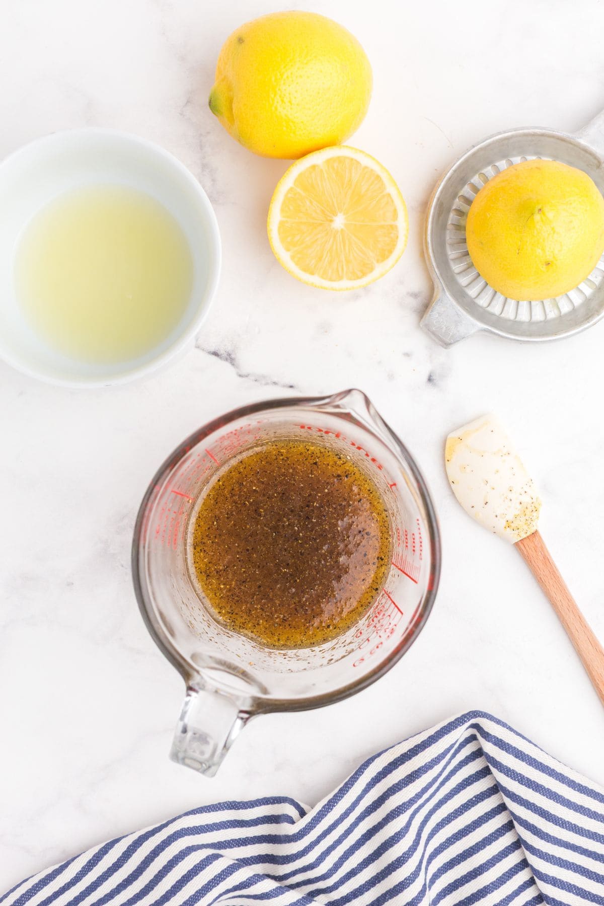 Completed lemon pepper sauce in a glass measuring cup.