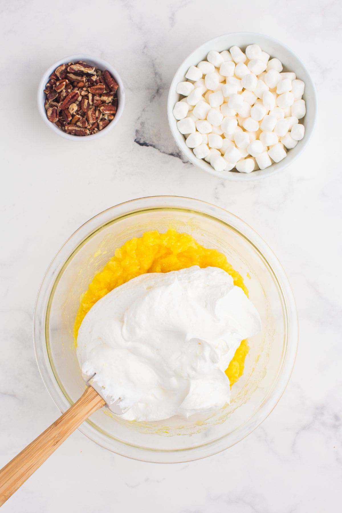 Cool Whip is folded into the pineapple mixture.