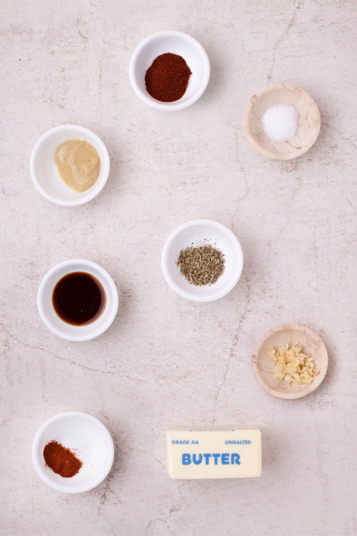 Ingredients for cowboy butter: butter, garlic, mustard, Worcestershire sauce, smoked paprika, Italian seasoning, salt, and cayenne pepper.