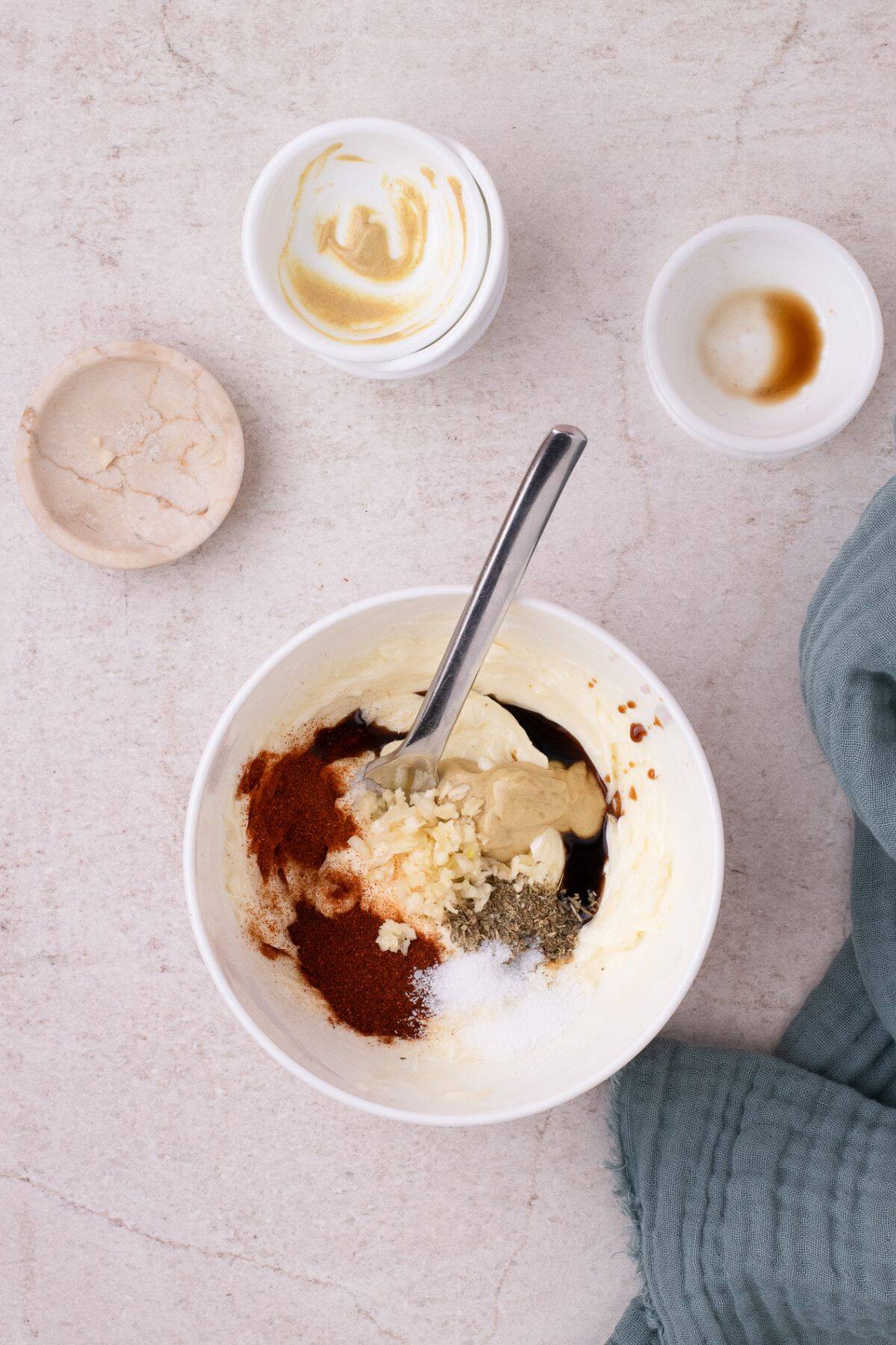 All ingredients added to the white bowl with softened butter.