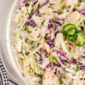Pineapple coleslaw in a glass serving bowl.