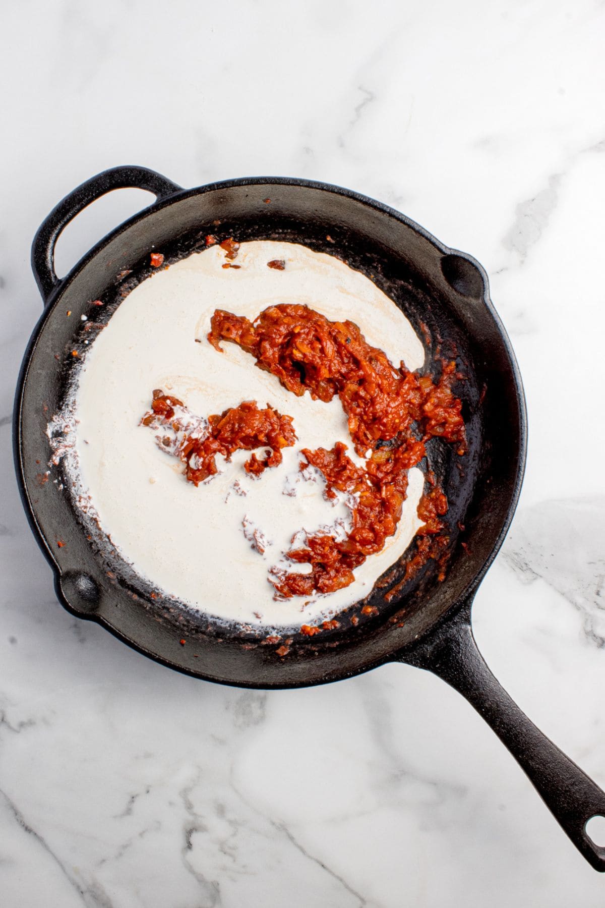 Vodka, tomato, and onion mixture is combined with heavy cream.