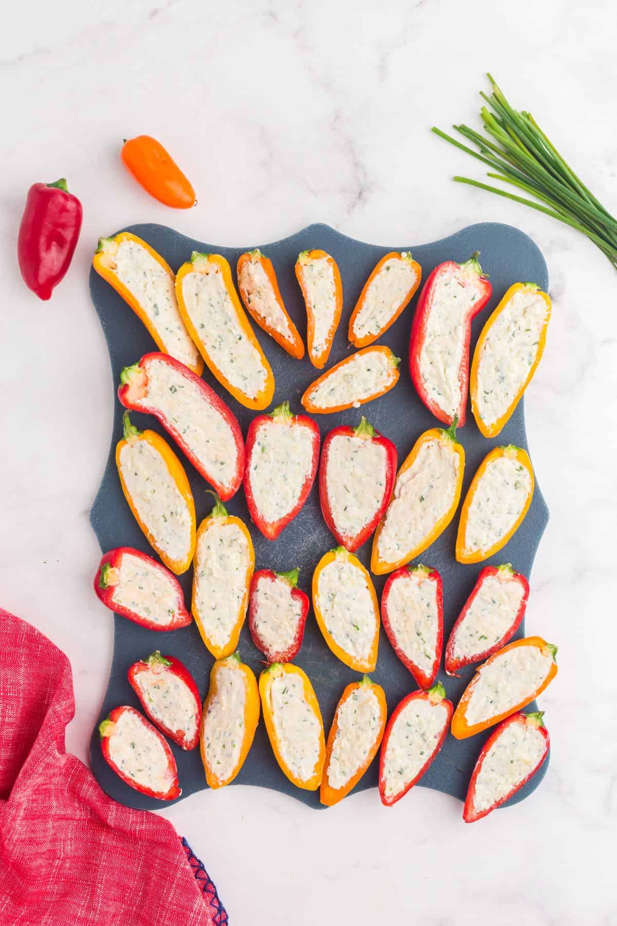 Peppers are stuffed with cream cheese mixture.