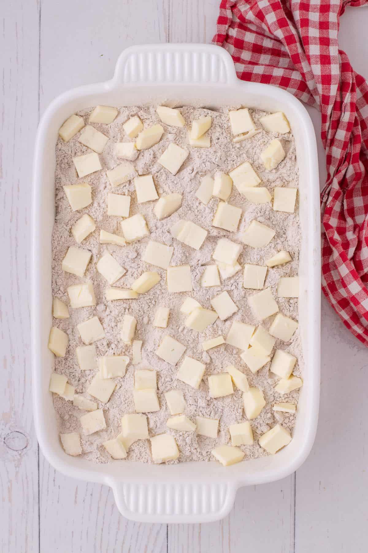 Chunks of butter evenly spaced along the top of the cake mix.