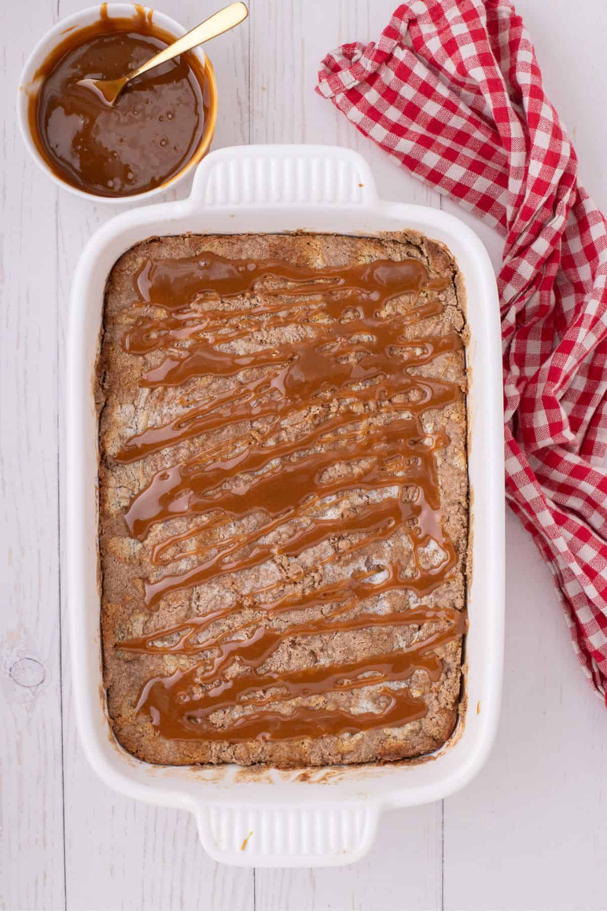 Caramel topping drizzled over the baked apple cake.