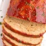 Closeup of the chicken meatloaf with half sliced.