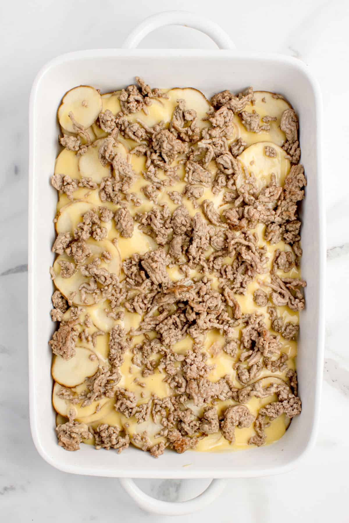 Add ground beef to the cheese sauce.