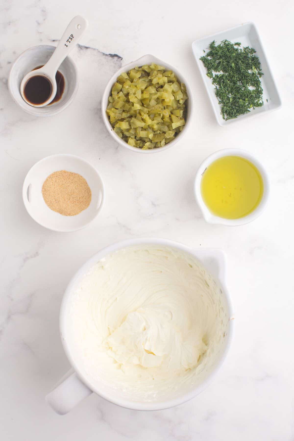 Whip sour cream and cream cheese together to make the base of the dip.