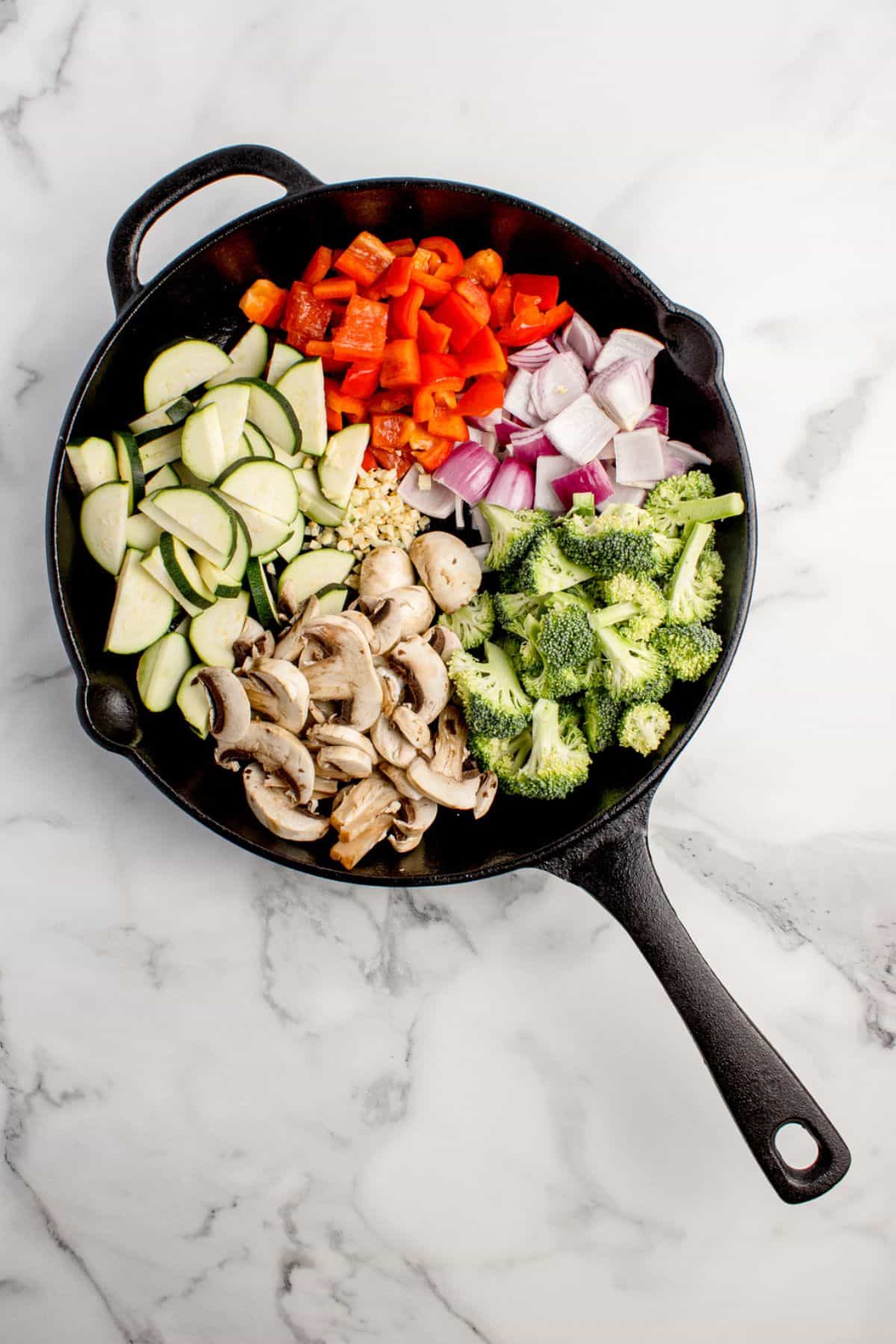 Fresh, chopped veggies in a cast iron pan.