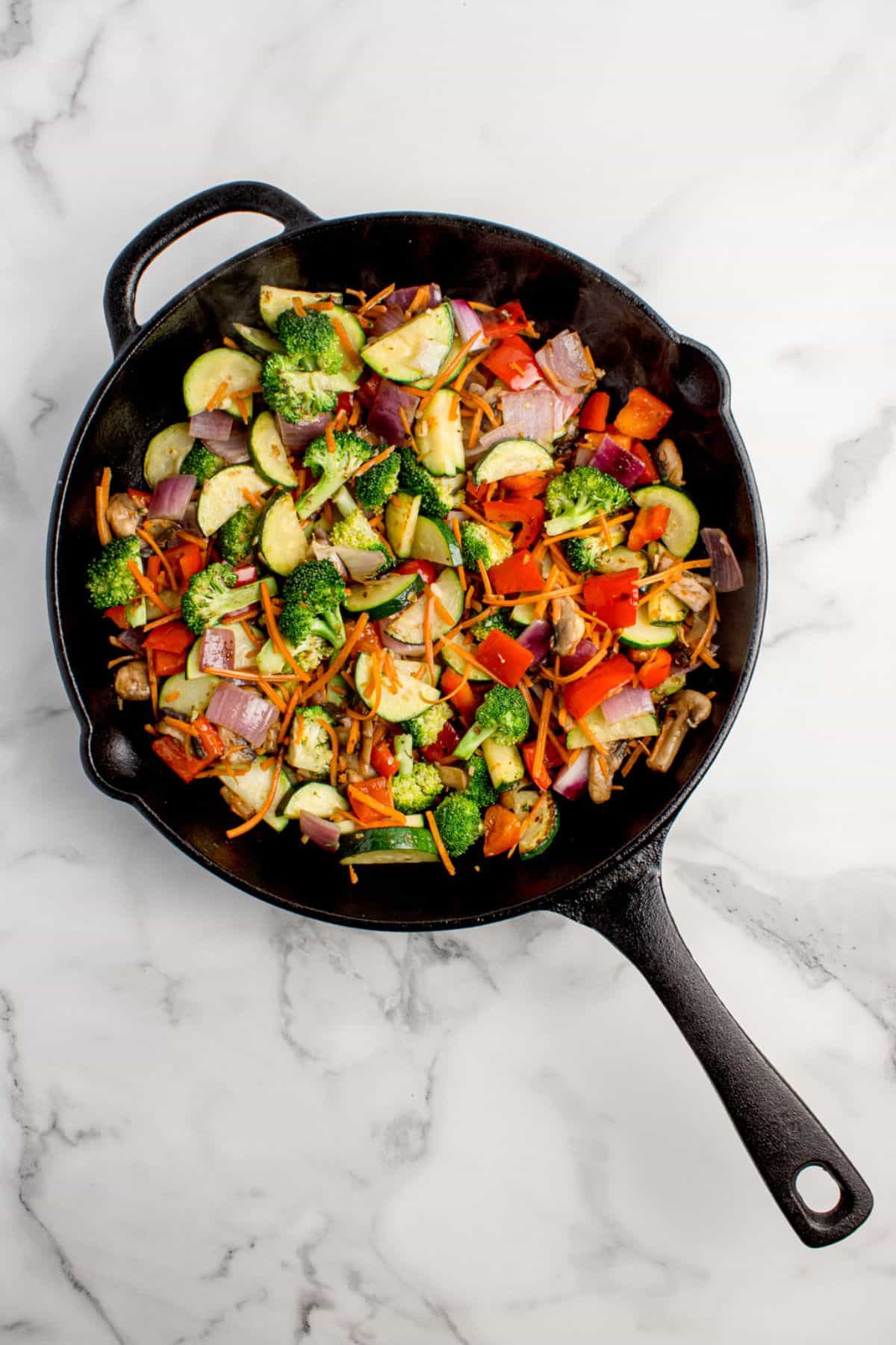Sauteed vegetables in a cast iron pan.