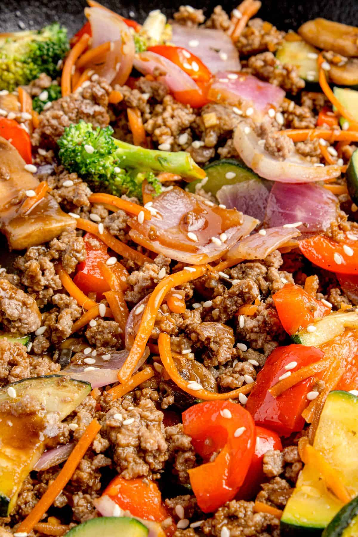 Ground beef stir fry in a cast iron pan.