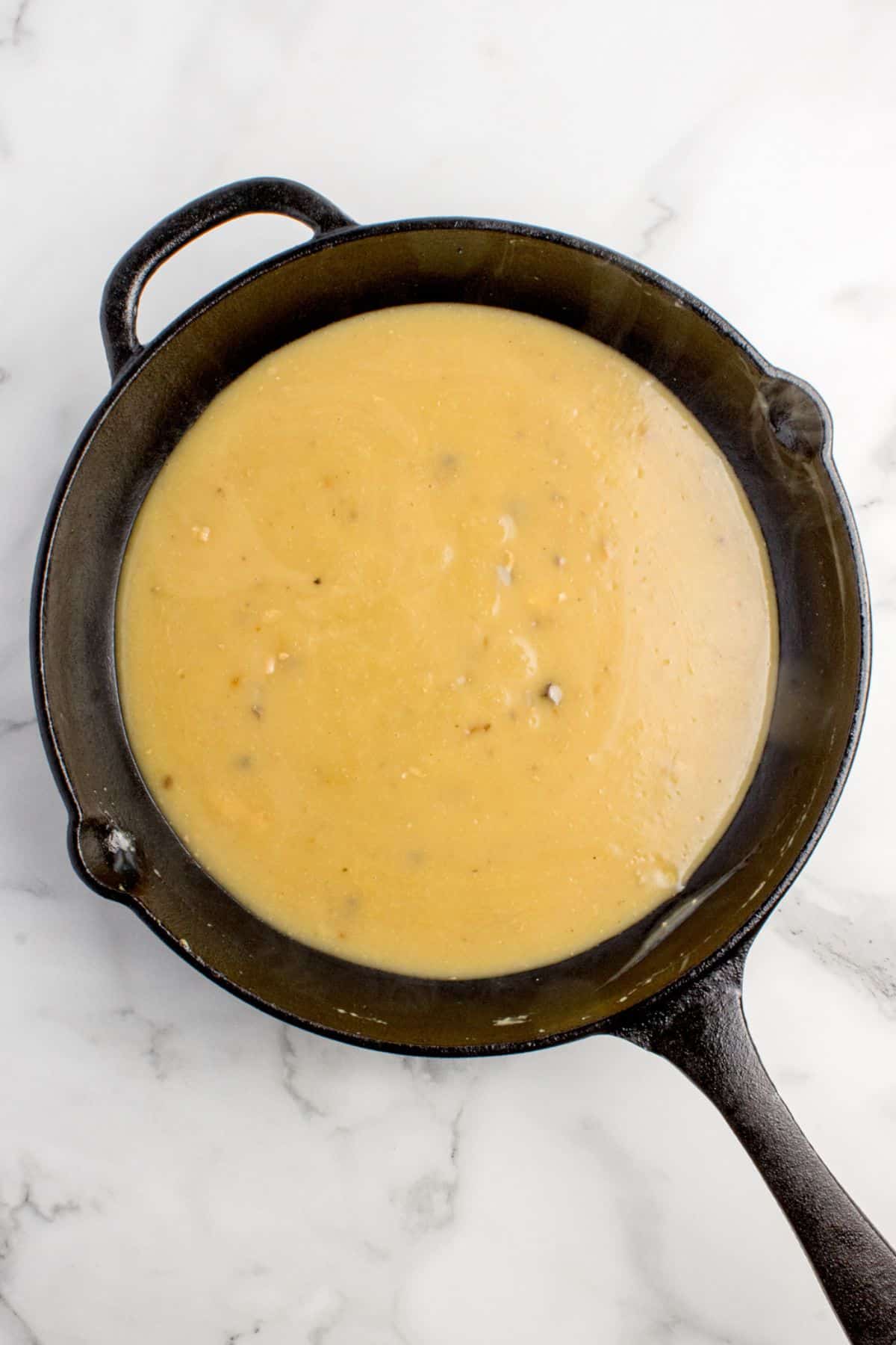 Gravy has been added to the cast iron pan.