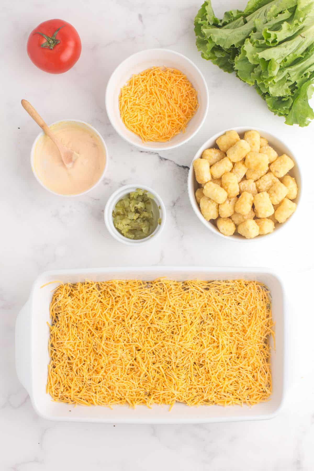 Layer big mac filling at the bottom of the baking dish, then sprinkle on a layer of cheese.