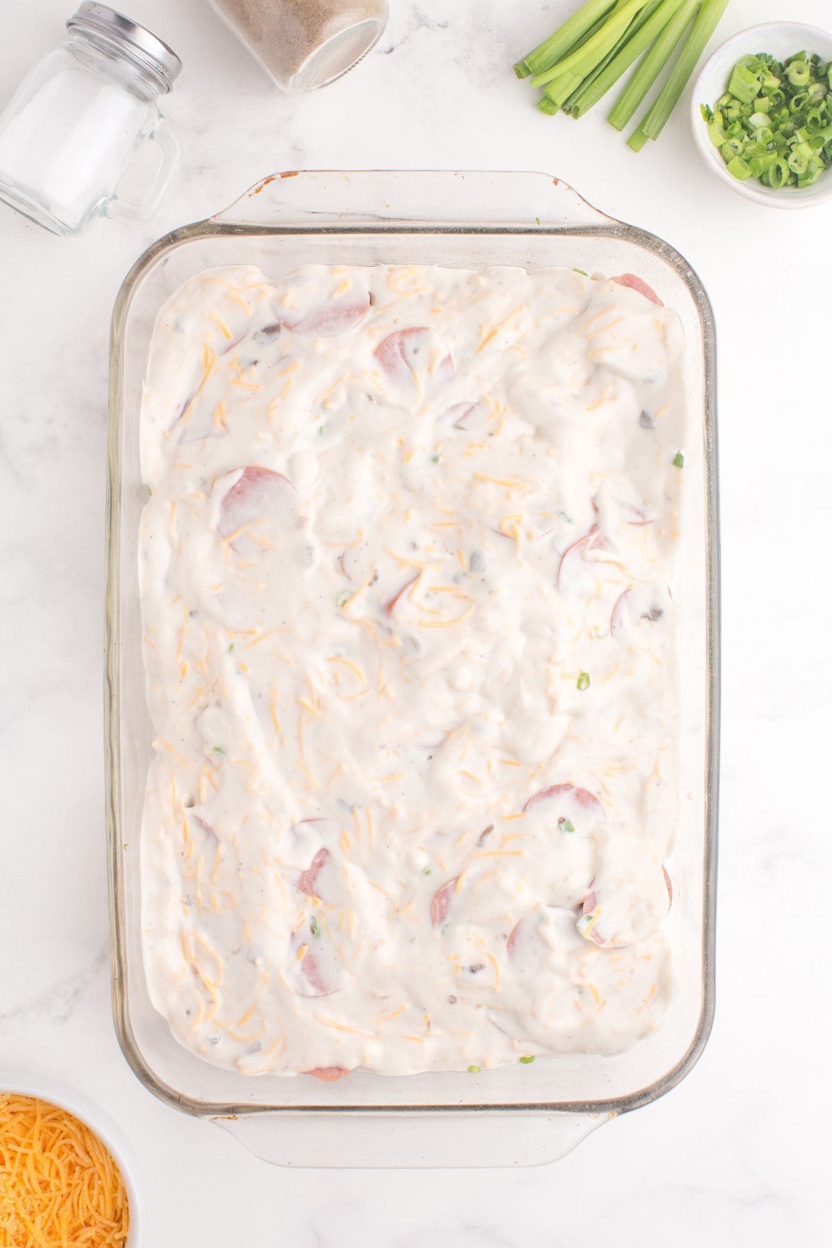 Sauce spread over the top of the casserole layers.