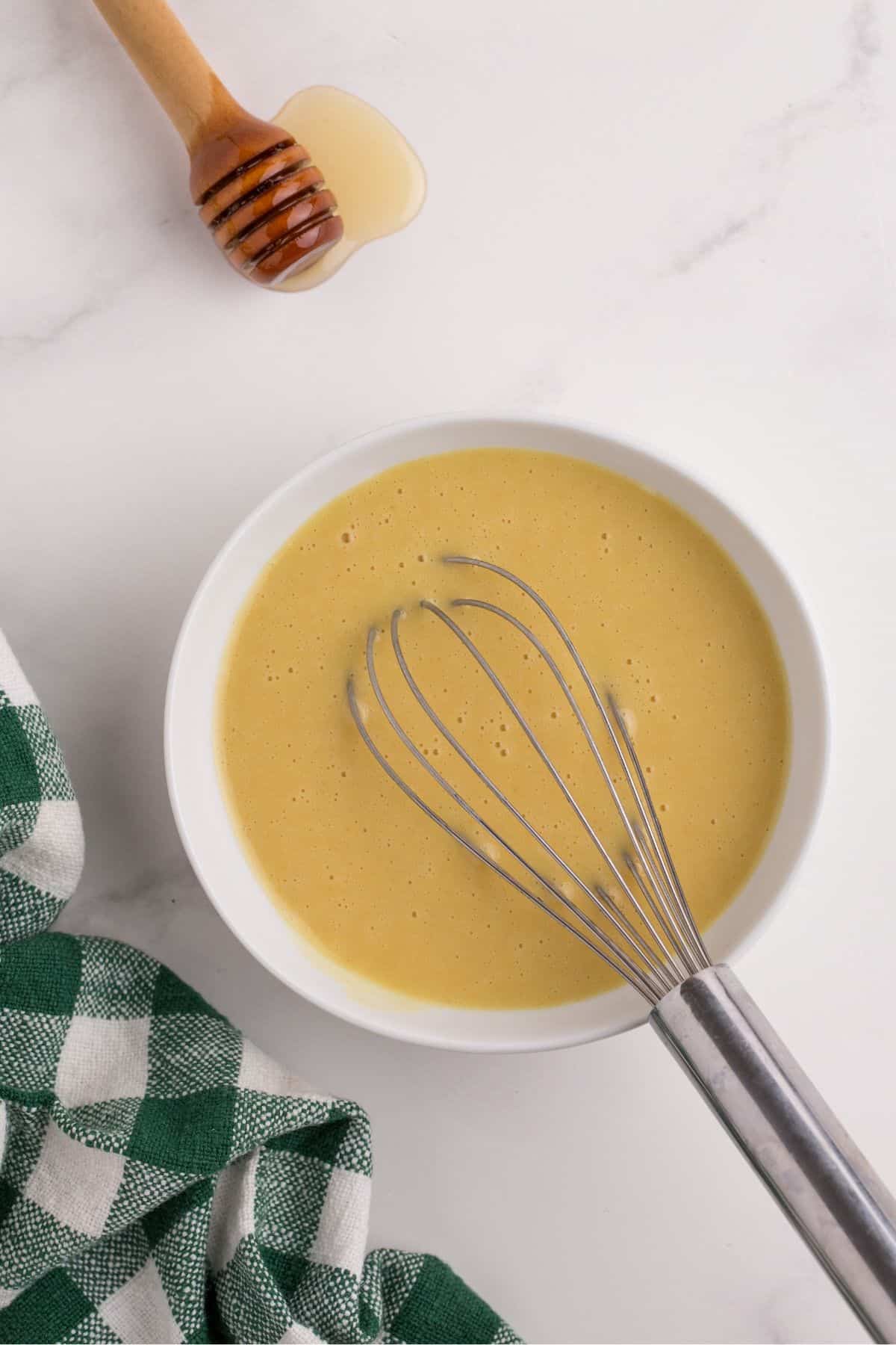 Honey mustard mixture is whisked together.